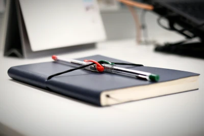 Pens resting on a manuscript notebook
