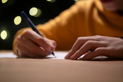 Hands writing on paper